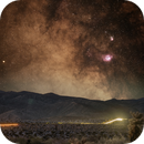 Lagoon and Trifid Nebulas rising over a desert road, Joe W
